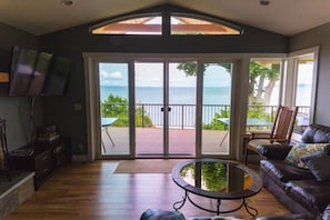 Living area on main floor has double glass doors that open to a waterfront deck.
