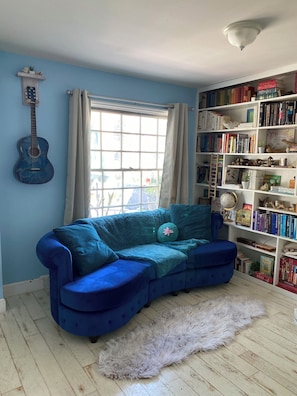 Living room sofa, window behind faces front  patio. Books are available to guest