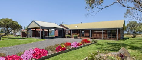 View of the Retreat from the driveway entrance which shows the 2 car carport.