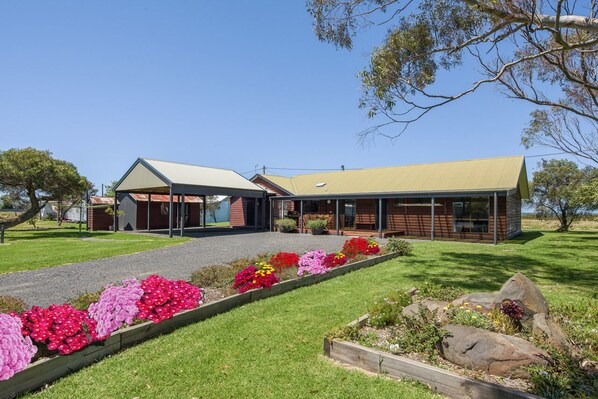 View of the Retreat from the driveway entrance which shows the 2 car carport.