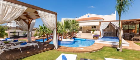 The pool terrace is equipped with sun beds.