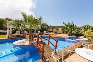 Great pool design with wooden bridge!