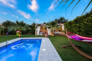 Relax in the hammock beside the pool, the perfect spot for unwinding.
