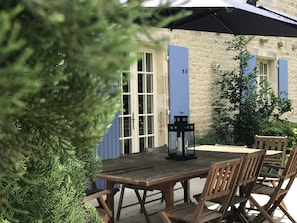 Dining on the back terrace overlooking the rear garden and swimming pool