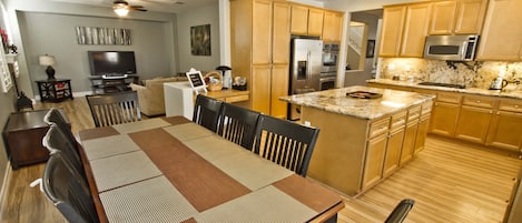 Great Room w/ 8 seater dining table, island bar counter overlooking kitchen