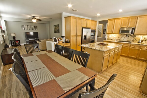 Great Room w/ 8 seater dining table, island bar counter overlooking kitchen