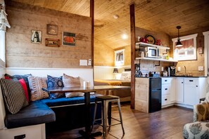 Kitchenette at front of cabin, banquette dining.  Bedroom with 2 queens!