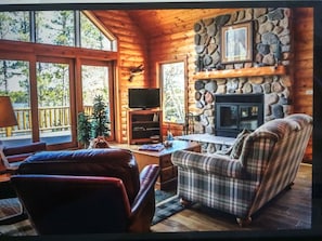 Fieldstone wood burning fireplace with views of lake right from couch!