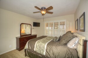 The second bedroom, with private bathroom and access to the porch and pool.