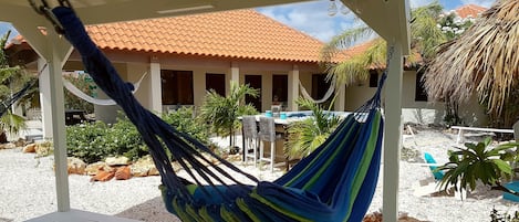 Opposite your apartment is a gazebo with 2 hammocks and chairs to relax