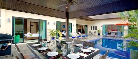 Moonstone Villa with 6 bedrooms sleeping 14 guests and offering large inside and outside dining tables, swimming pool and spacious sun deck, adjacent to the gas BBQ, ideal for Al Fresco evening dining