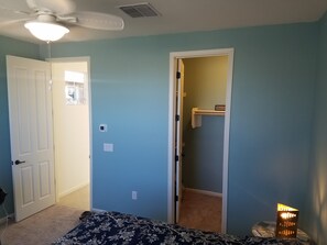 Spacious room with walk in closet and ceiling fan.