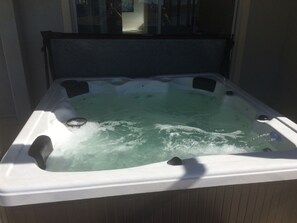 Private hot tub spa under the covered and screened lanai.