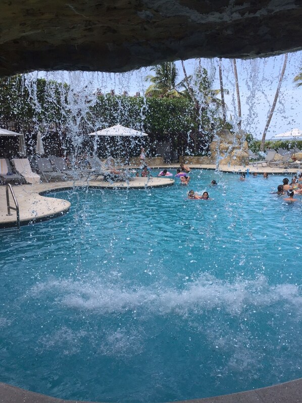 Hotel pool with a water fall 