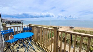 Balcony deck off second floor bedroom has a bistro table and amazing views