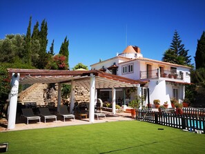 Shared grass area and shaded terrace.