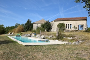 The pool with summer kitchen and house