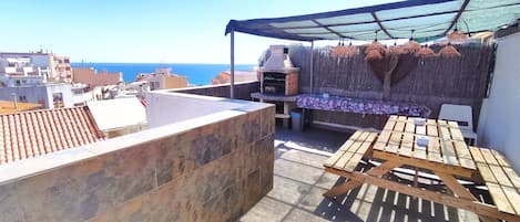 Big terrace (one of three), barbecue, picnic-table and benches. Sea view.