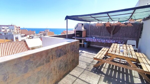 Big terrace (one of three), barbecue, picnic-table and benches. Sea view.