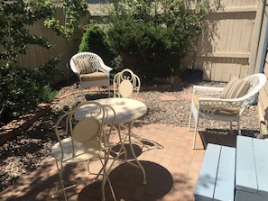 Upper patio bistro set and steps up to patio door into living room/dining room.