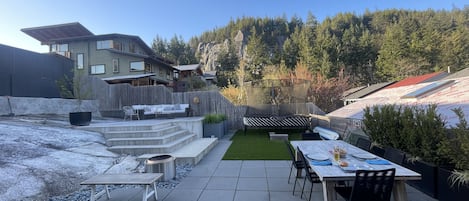 Gorgeous backyard with incredible views of Smoke Bluffs, trampoline and fire pit