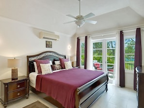 The spacious master bedroom, with a king bed, A/C, walk-in closet, en-suite bathroom and private terrace