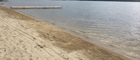 Private sandy beach with dock