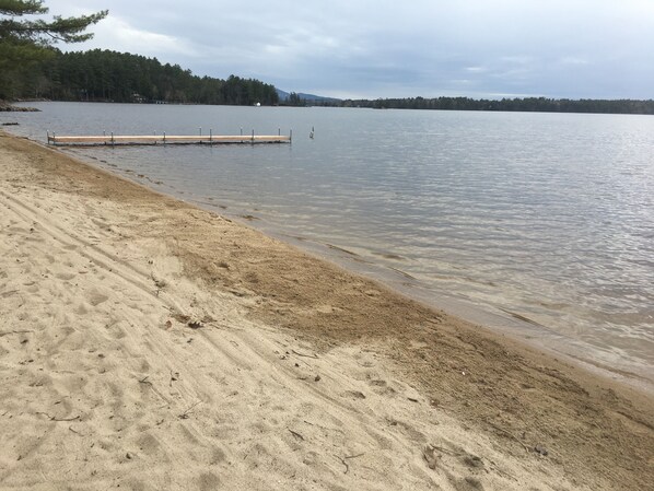 Private sandy beach with dock
