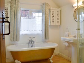 Master en suite with roll top bath & shower cubicle