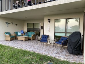 Oversized bottom floor  patio with views of the pool, tennis courts and beach