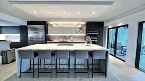 Large island, induction cooktop, seating for five.