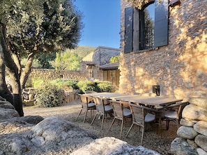 Outside dining table seating up to 10 guests under the oak trees