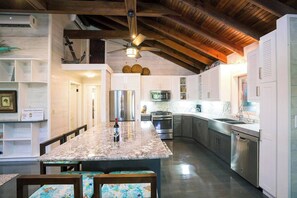 Spacious kitchen with large central island, fully equipped with all your culinary needs.