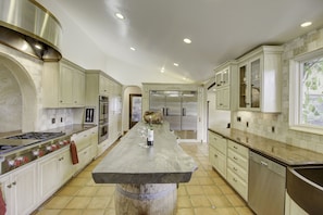 Chef's kitchen featuring Wolf stove, double oven, commercial fridge system