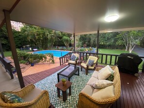 Front veranda wtih lounge seating and bbq overlooking pool