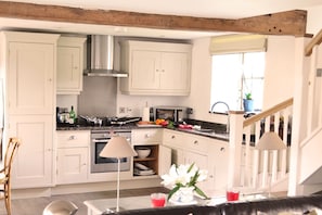 Ground floor: Kitchen area in the open plan living space with exposed beams