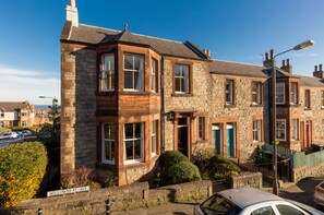 This is an end of terrace house with a garden