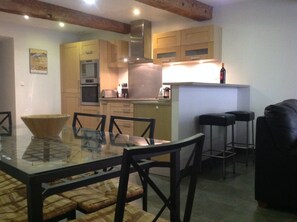Granite and white oak kitchen  and open plan living area.