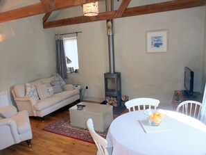 Spacious living room with wood burner