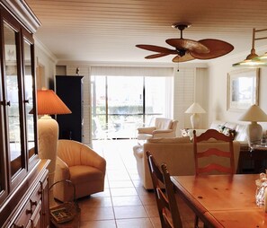 View of the dining room, living room, through to the glassed-in lanai. 