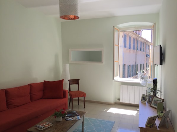 Large, sunny living room with two pull-out couches for lounging or sleeping.