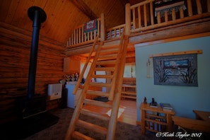 View from futon towards log loft ladder and kitchen
