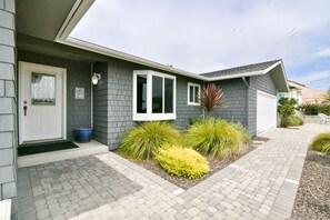 The beautifully landscaped front yard welcomes you to this beachfront getaway