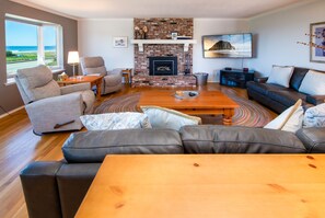 The living room has a flat screen TV and fireplace
