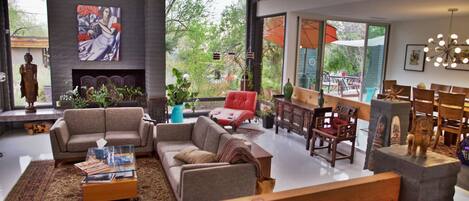 Spacious living room is bright and surrounded by picture windows