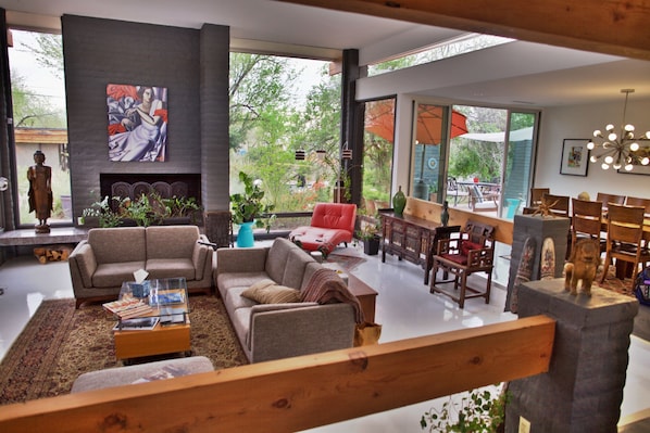 Spacious living room is bright and surrounded by picture windows