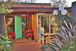 Front entrance with bubbling water feature and two sitting and dining areas