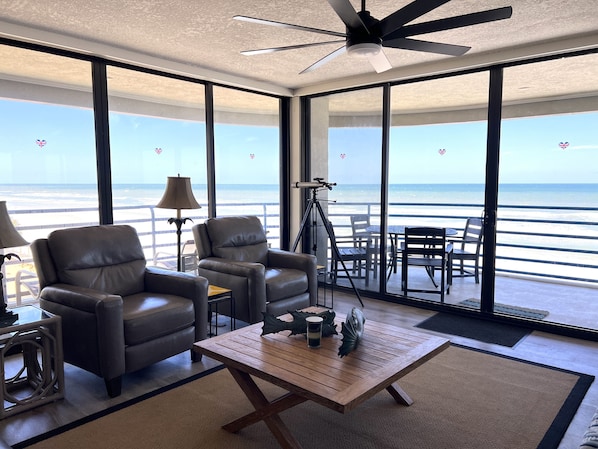 Beautiful beach views from the living room with new recliner chairs and sofa.