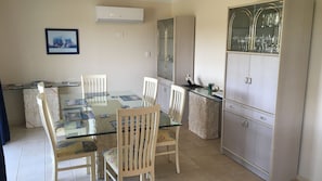 Dining area including 6-seat table setting & glass cabinet