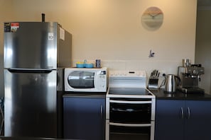 Kitchen appliances including microwave, new stove & espresso coffee machine